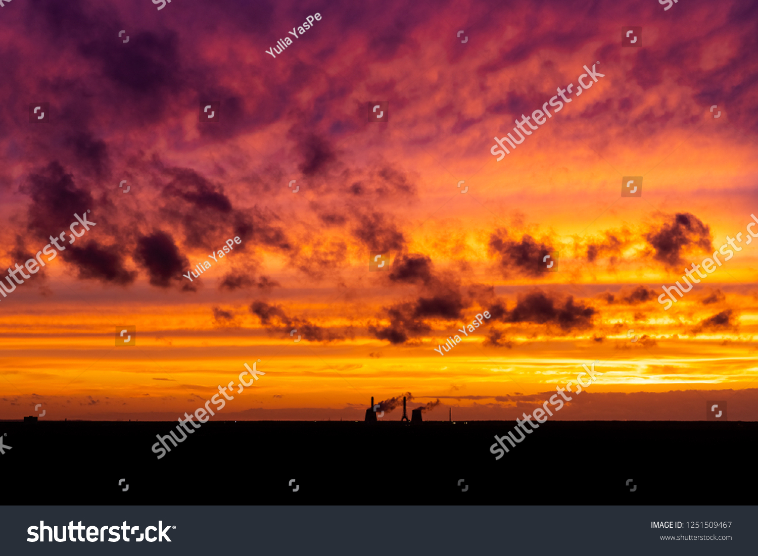 Cloudy sunset and shade of building.Dramatic red yellow sunset over the city industry. Red clouds.Panoramic view of sunset in the city with silhouette of buildings and industrial cranes, high way #1251509467