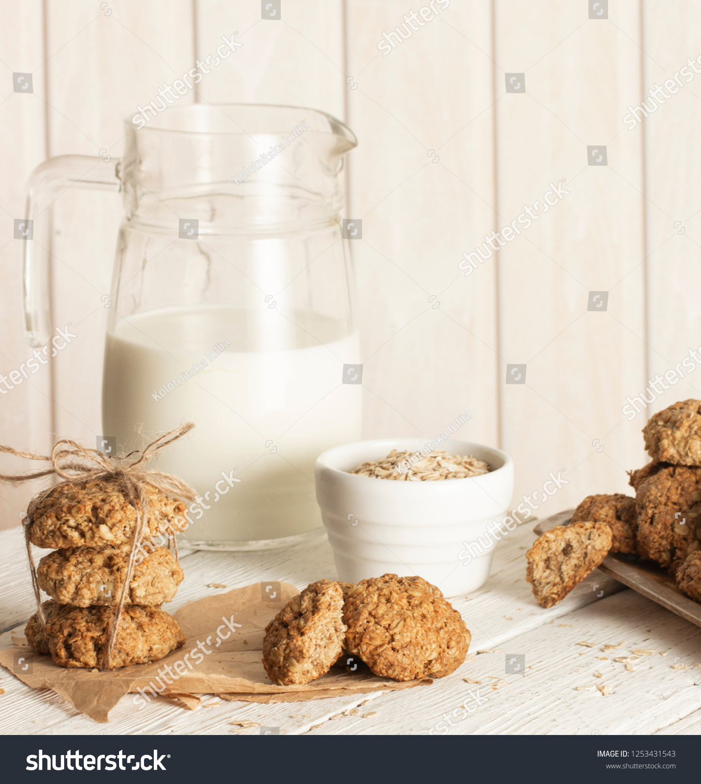 Oatmeal cookies with milk on tray on rustic wooden table #1253431543