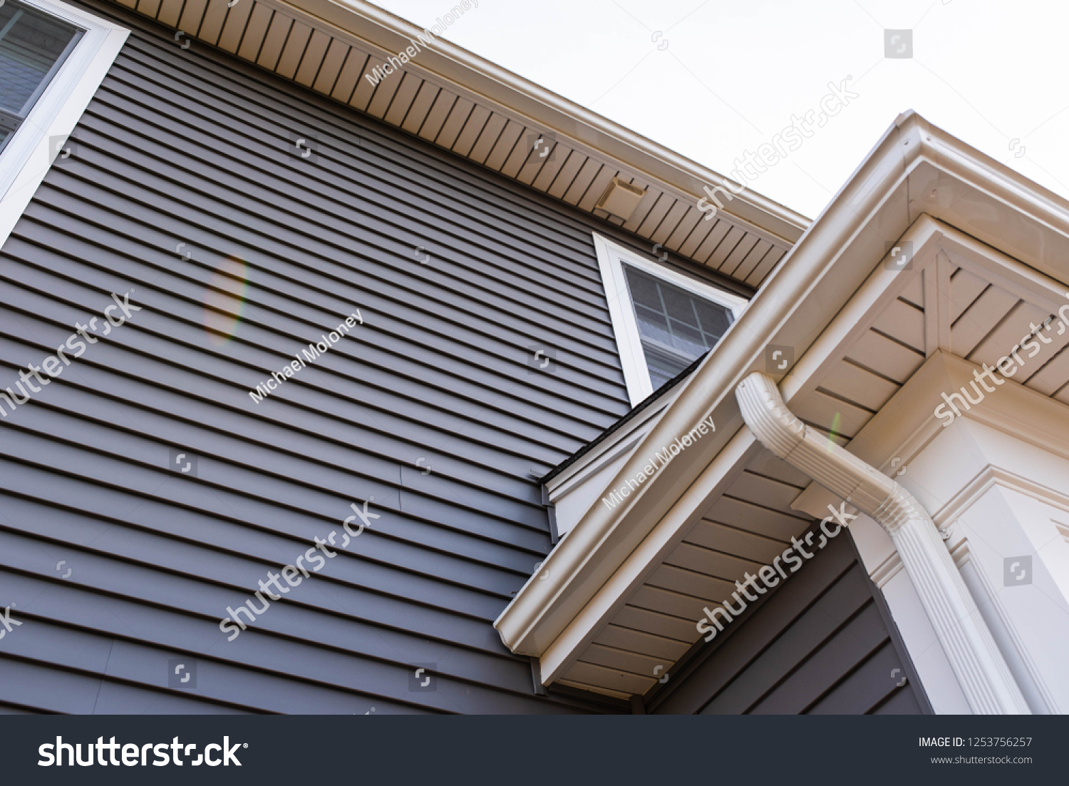 vinyl siding up the side of a new house #1253756257