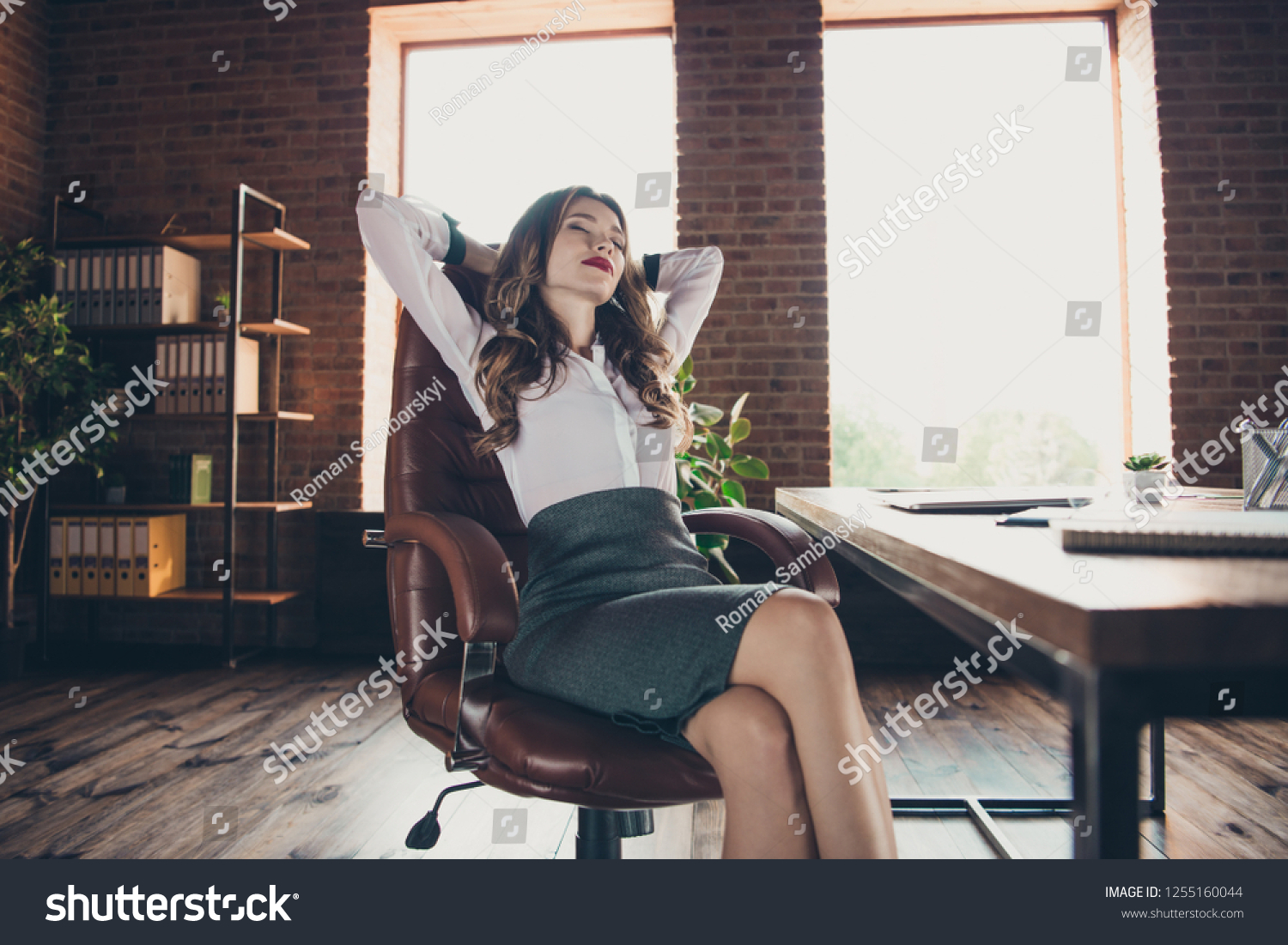 Low below angle view of nice lovely elegant classy attractive adorable charming wavy-haired lady closed eyes sitting in chair at work place station open space #1255160044