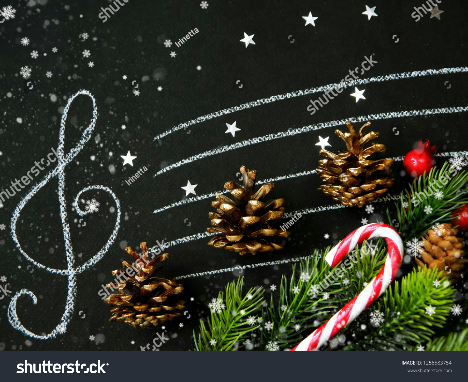 Golden fir cones, fir branches, Christmas decor on the stave with treble clef. Holiday background. #1256583754