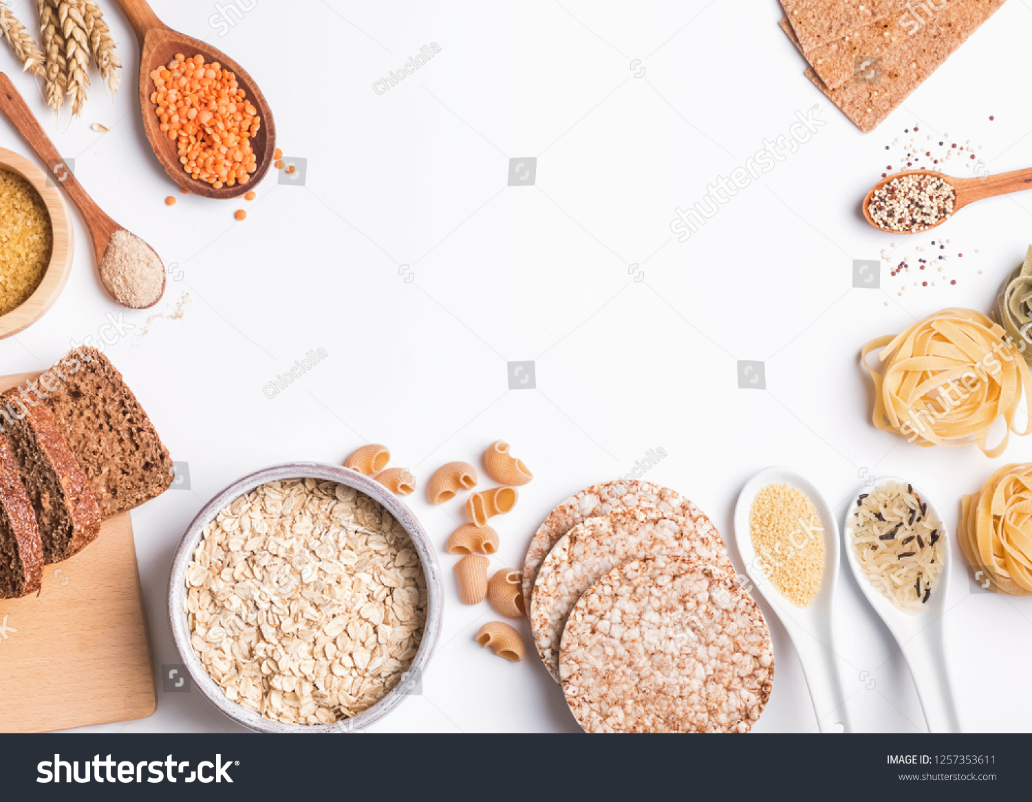 Different types of high carbohydrate food. Flour, bread, dry pasta and lentils and other ingredients on the white background. #1257353611