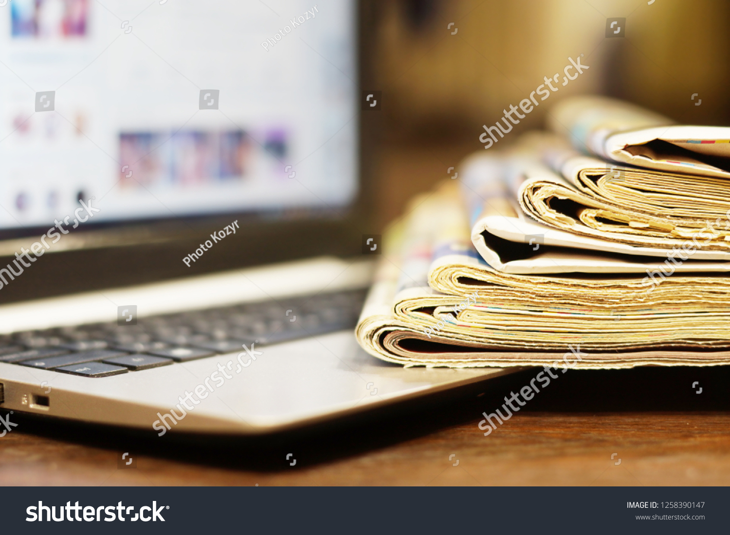 Newspapers and Laptop. Different Concepts for News - Social Network or Traditional Tabloid Journals. Data Sources - Electronic Screen of Computer or Paper Pages of Magazines, Internet or Papers #1258390147