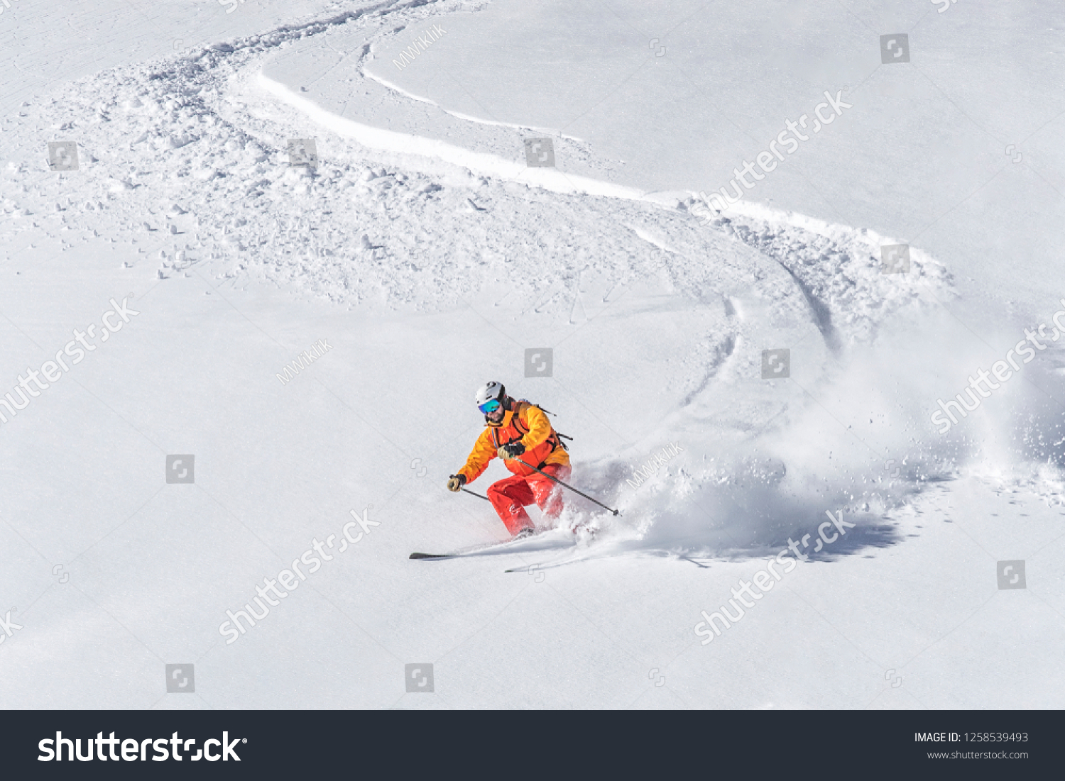 one freeride skier skiing downhill trough deep fresh powder #1258539493