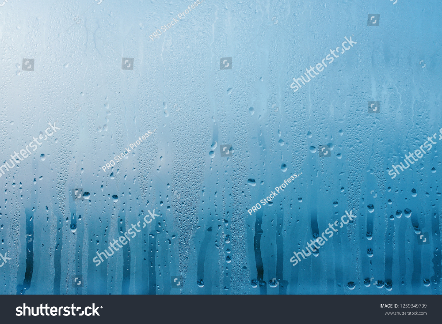 Condensation on the clear glass window. Water drops. Rain. Abstract background texture #1259349709