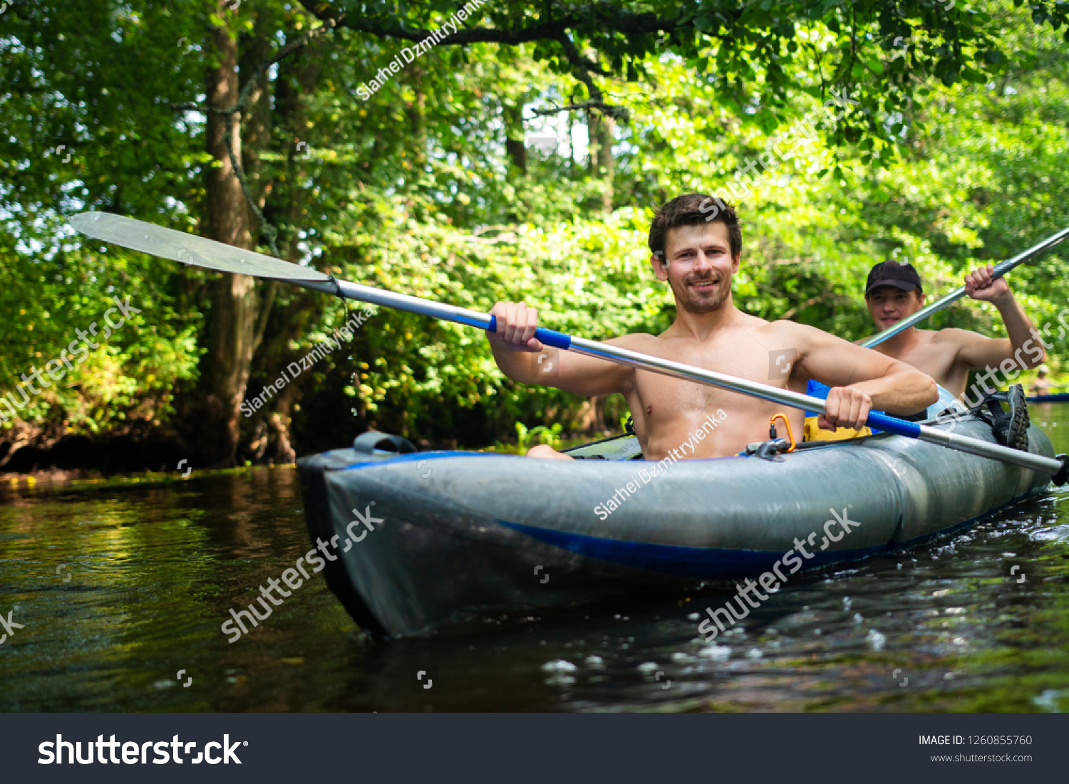 Kayaking. Friends in kayak with oars. Two men in canoe. People in boat. Active summer vacation #1260855760