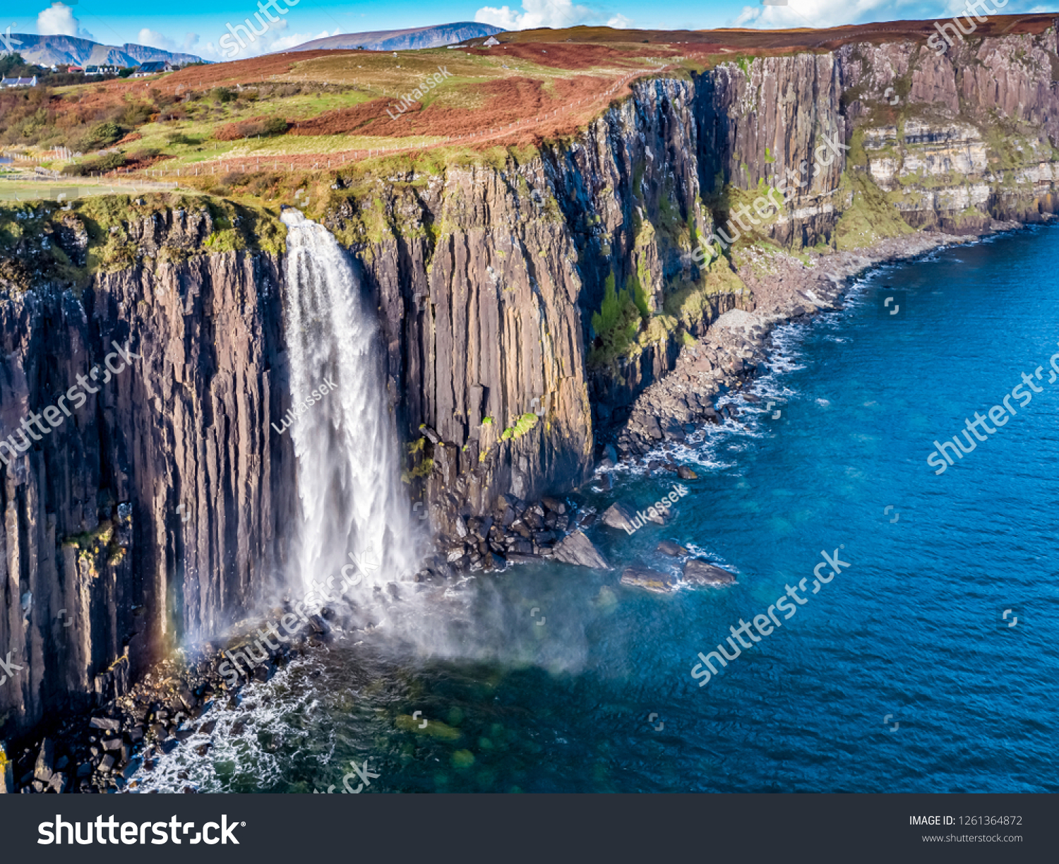Aerial view of the dramatic coastline at the cliffs by Staffin with the famous Kilt Rock waterfall - Isle of Skye - Scotland. #1261364872