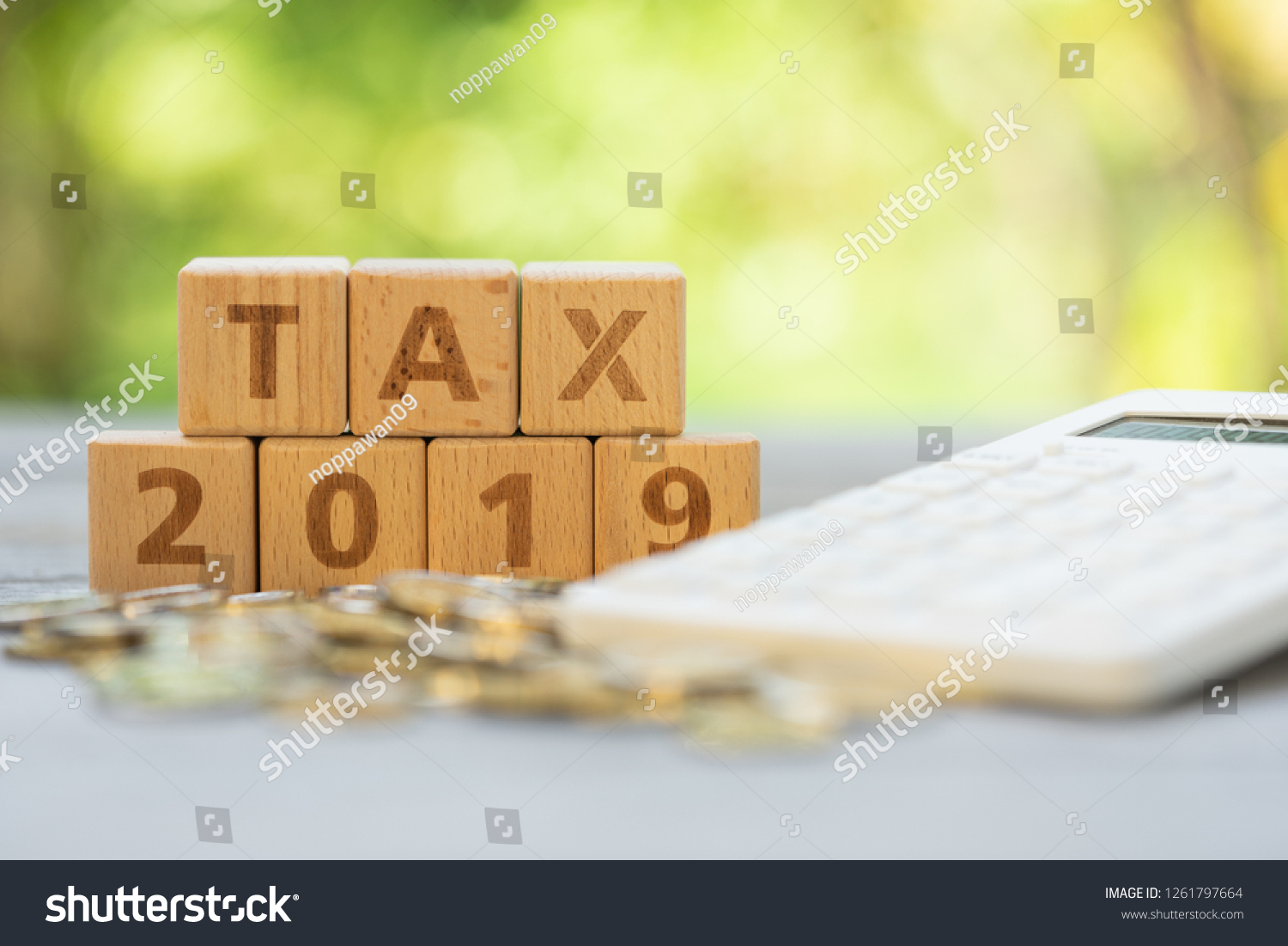 Word block "TAX", and "2019" on pile of coins with calculator as background. Income, expenses, tax, financial data. #1261797664