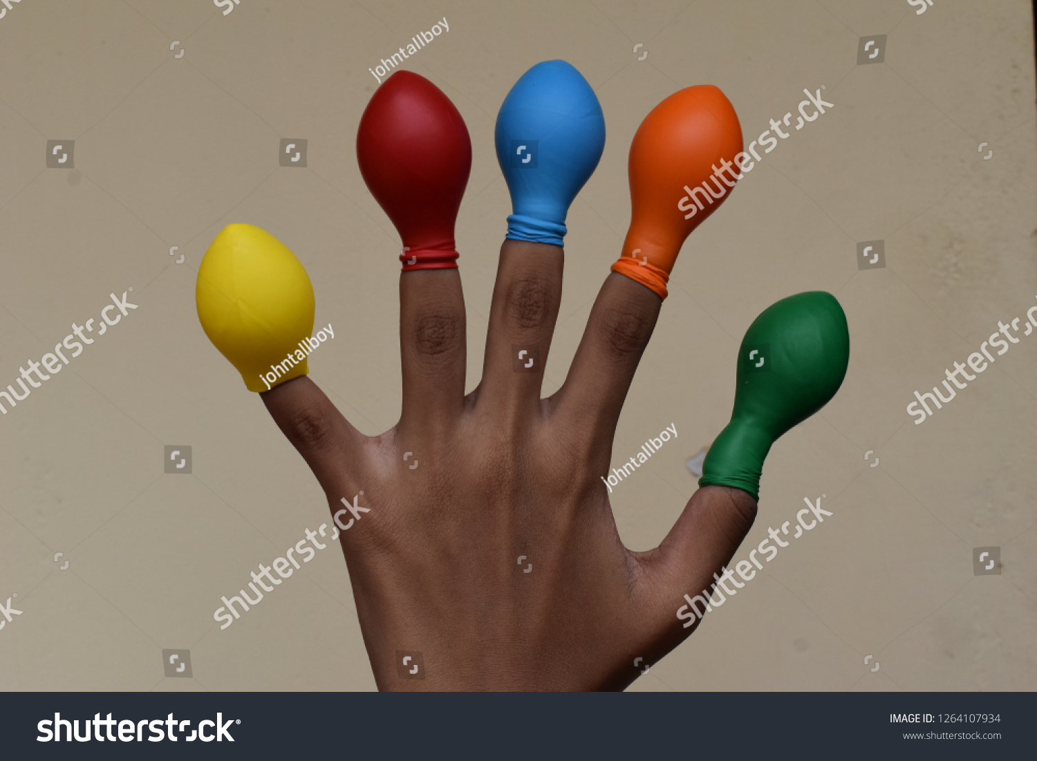 Balloon on finger or kids wearing balloon on fingers  #1264107934