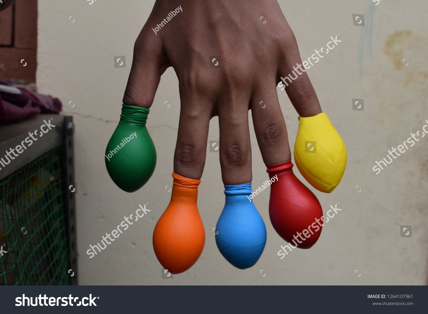 Balloon on finger or kids wearing balloon on fingers  #1264107961