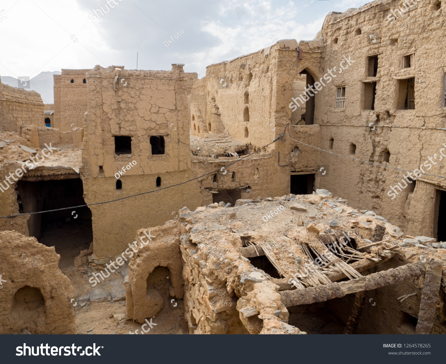 Panoramic view of several ancient mud brick houses ruins in Al Hamra, Oman #1264578265