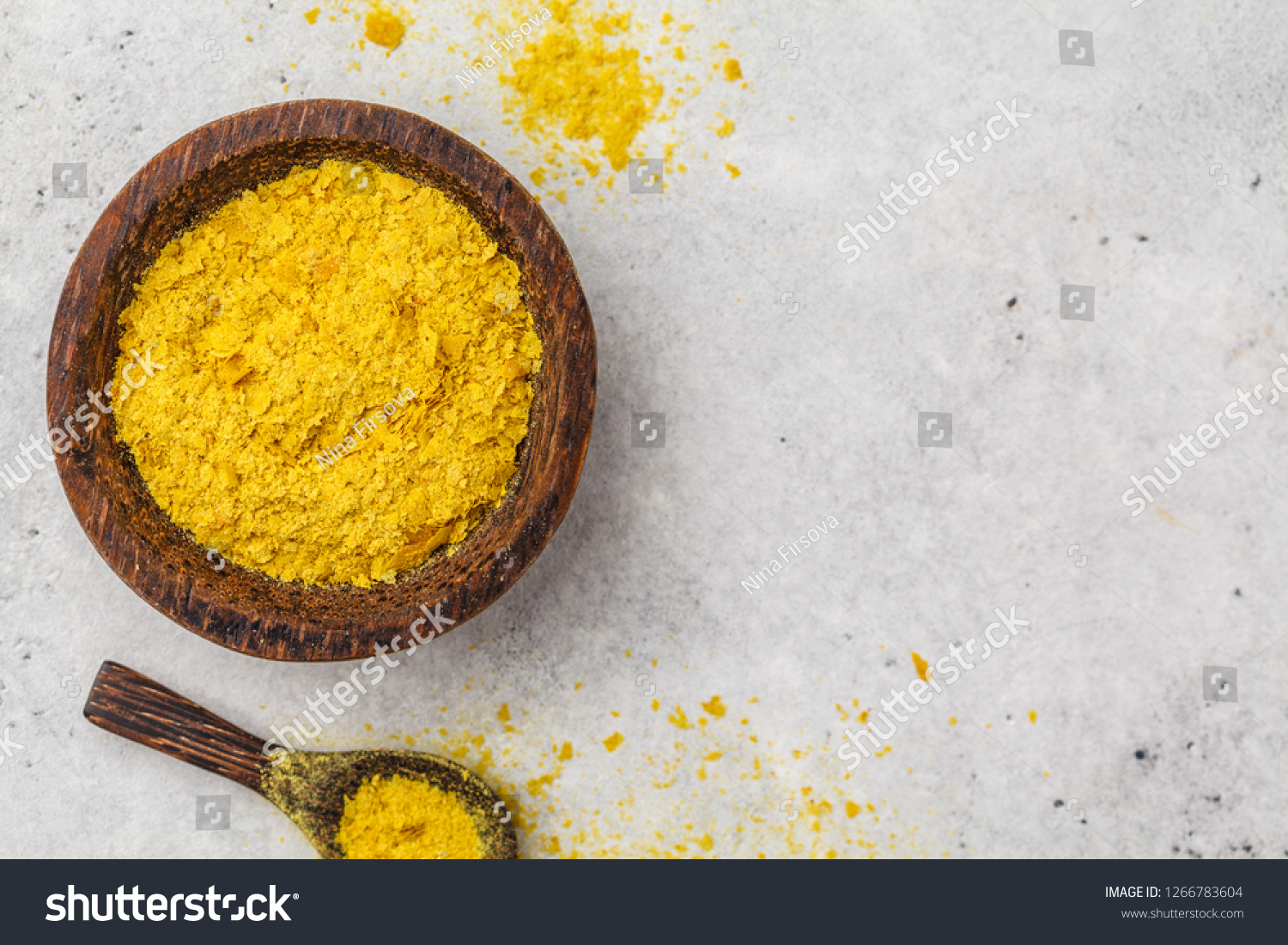 Nutritional yeast in a wooden bowl, copy space, white background, copy space. Healthy vegan food concept. #1266783604
