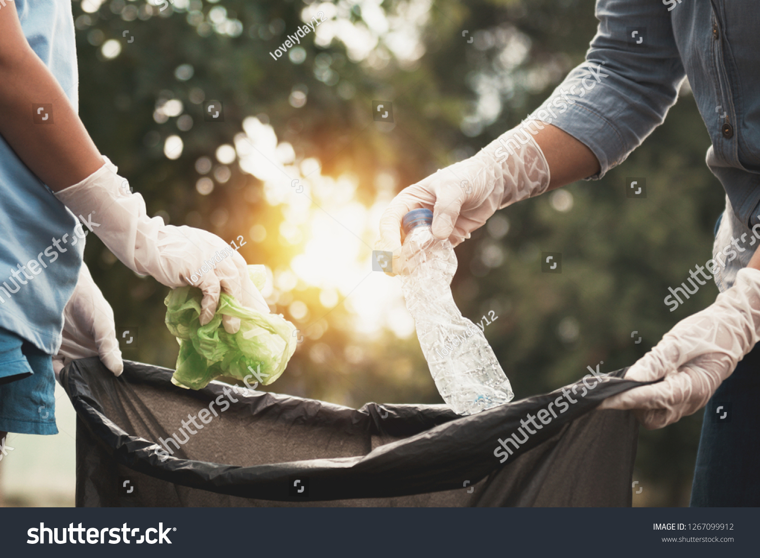 woman hand picking up garbage plastic for cleaning at park #1267099912
