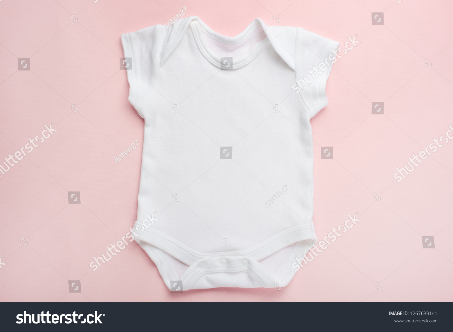 Layout Flat Lay white baby shirt bodysuit, on a pink background, for girls. Mock up for design and placement of logos, advertisements #1267639141