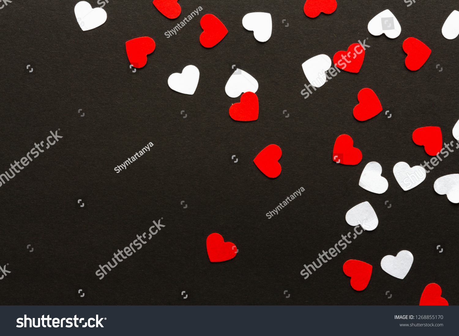 Valentines day. Paper hearts red and white on a black background. Holiday background #1268855170