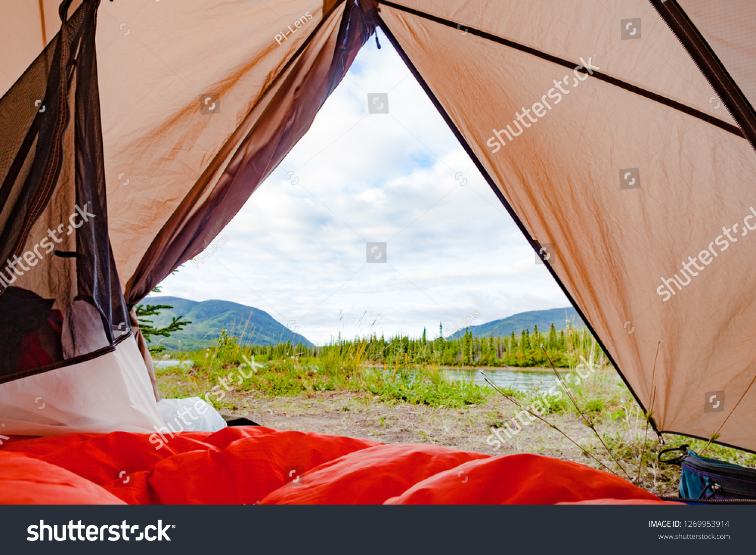 Campsite wilderness nature view of Yukon River, Yukon Territory, YT, Canada, from inside a tent with sleeping bag laid out #1269953914