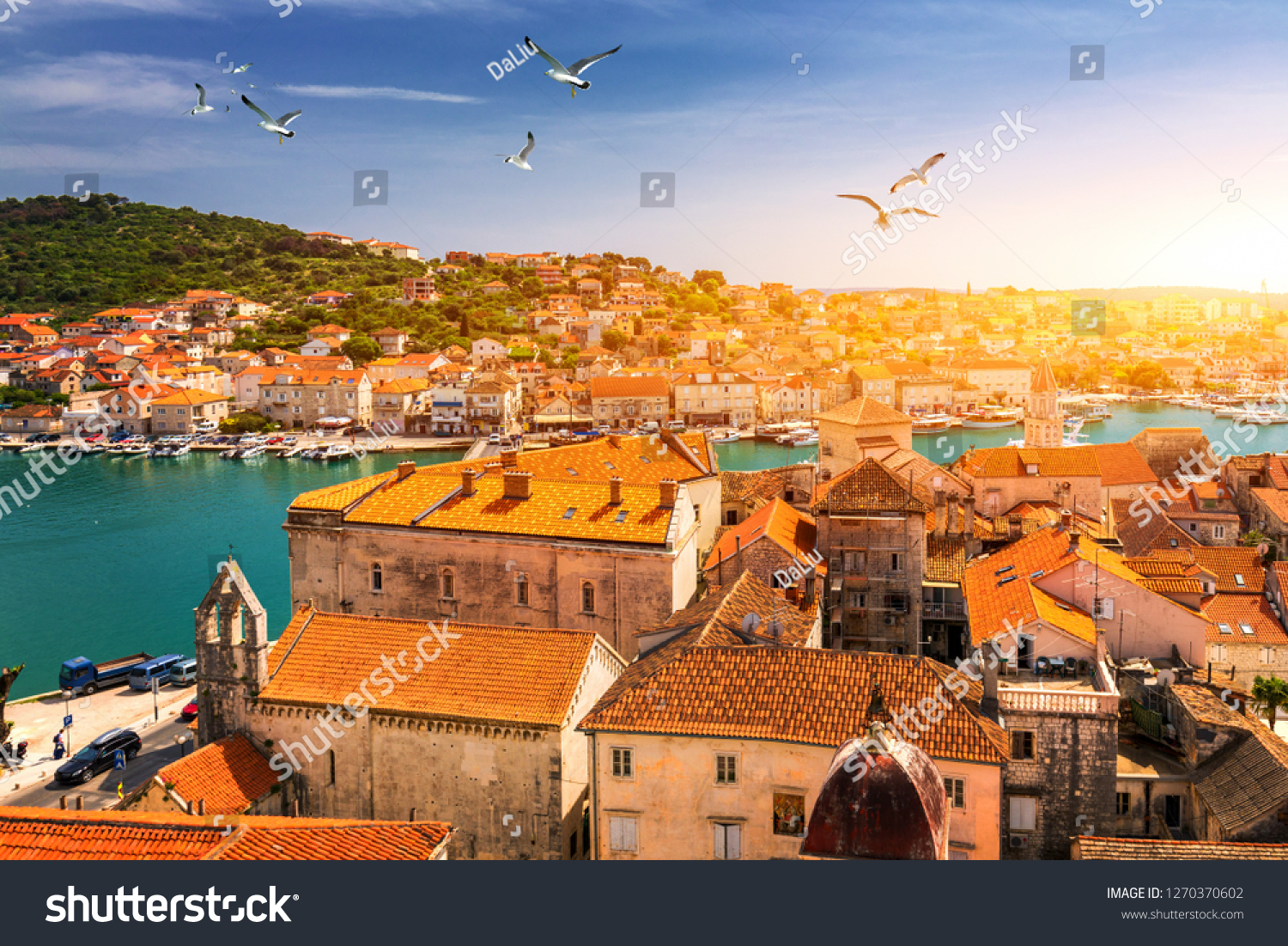 View at town Trogir, old touristic place in Croatia Europe with seagull's flying over city. Trogir town coastal view. Magnificent Trogir, Croatia. Sunny old Venetian town, Dalmatian Coast in Croatia. #1270370602