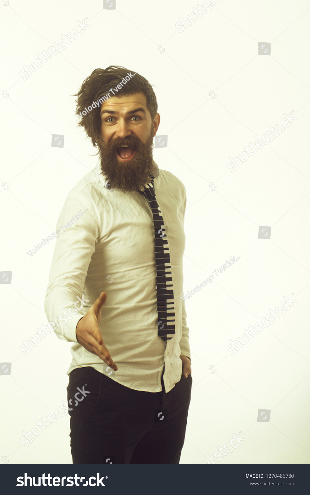 Hipster in shirt and musical tie. Guy hold hand for handshake. Business fashion and beauty. Fashion model with stylish hair isolated on white. Man with long beard and mustache on happy face. #1270486780