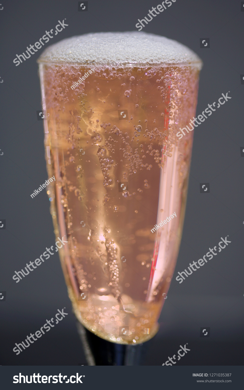 Champagne. Pink Champagne in a Glass. Champagne bubbles in a Champagne Glass. New Years Eve.  #1271035387
