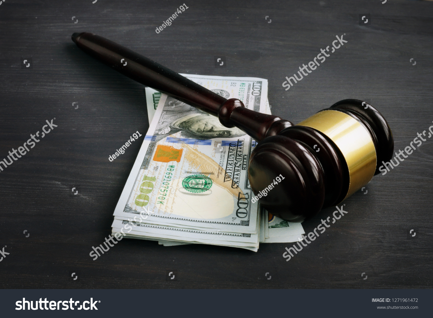 Gavel and money in the court. Penalty or bribe. #1271961472
