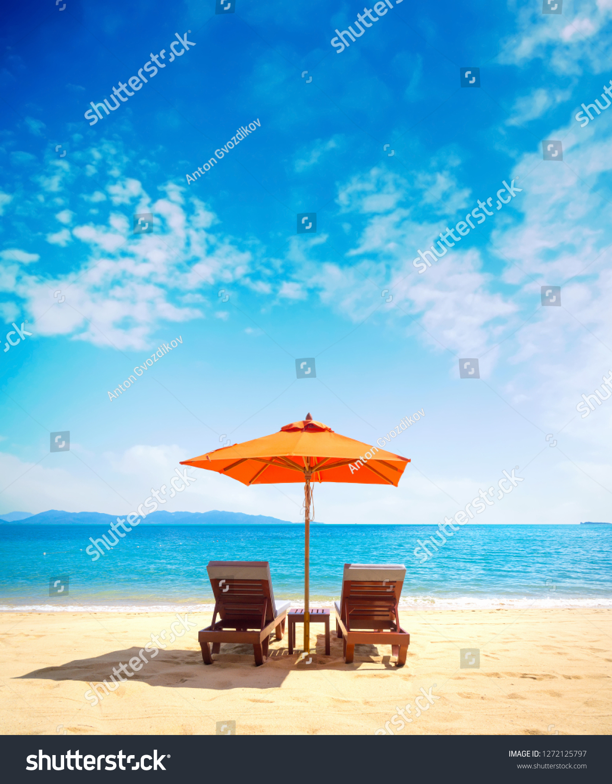 Two lounge chairs with sun umbrella on a beach #1272125797