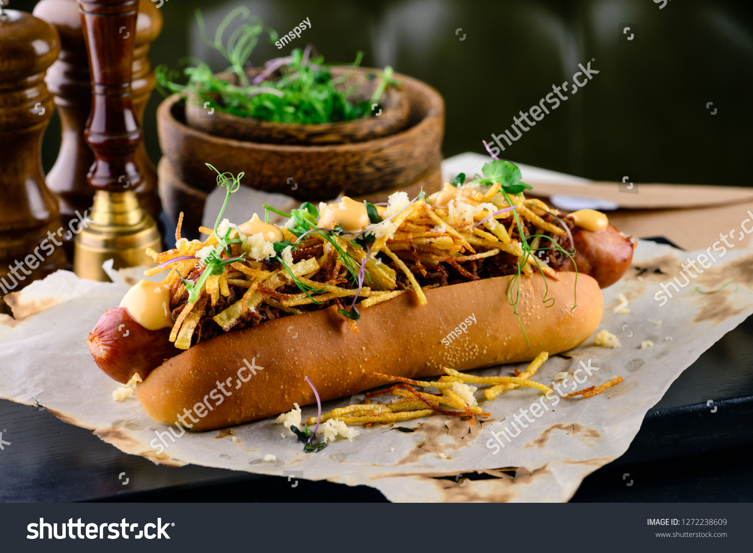 Delicious grilled hotdog in a restaurant, Homemade Bacon Wrapped Hot Dogs with Onions and Peppers #1272238609