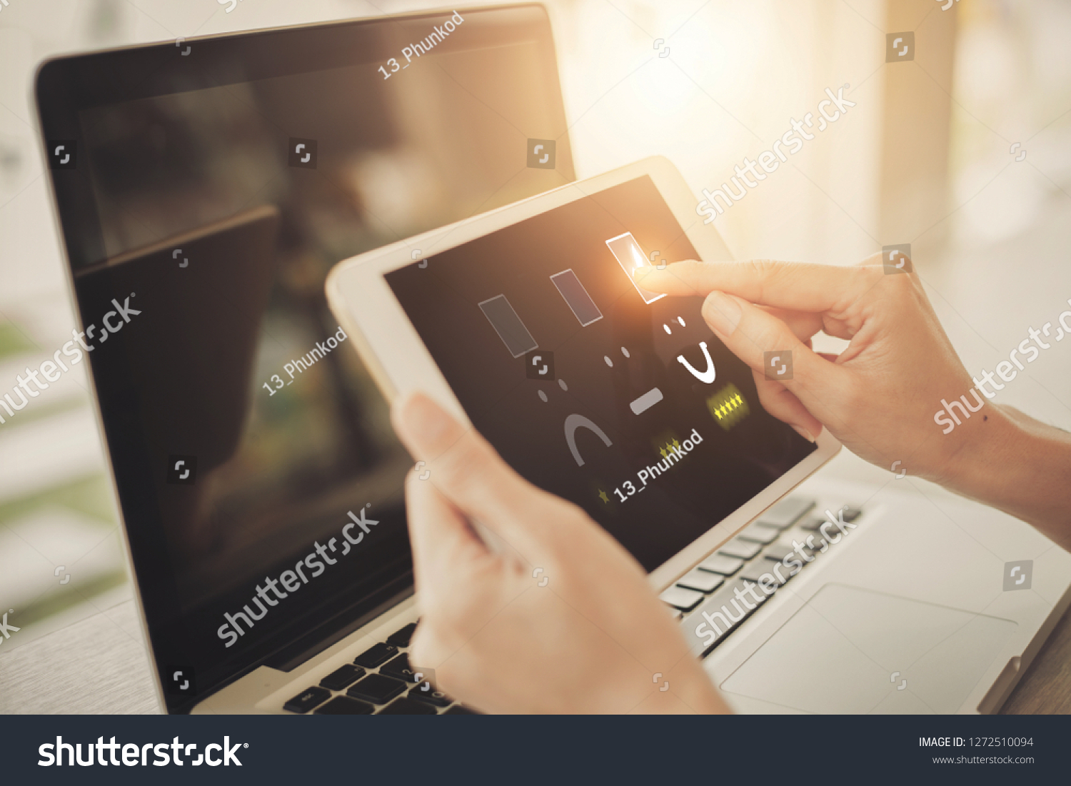 Businesswoman pressing face emoticon on virtual touch screen at digital tablet .Customer service evaluation concept. #1272510094