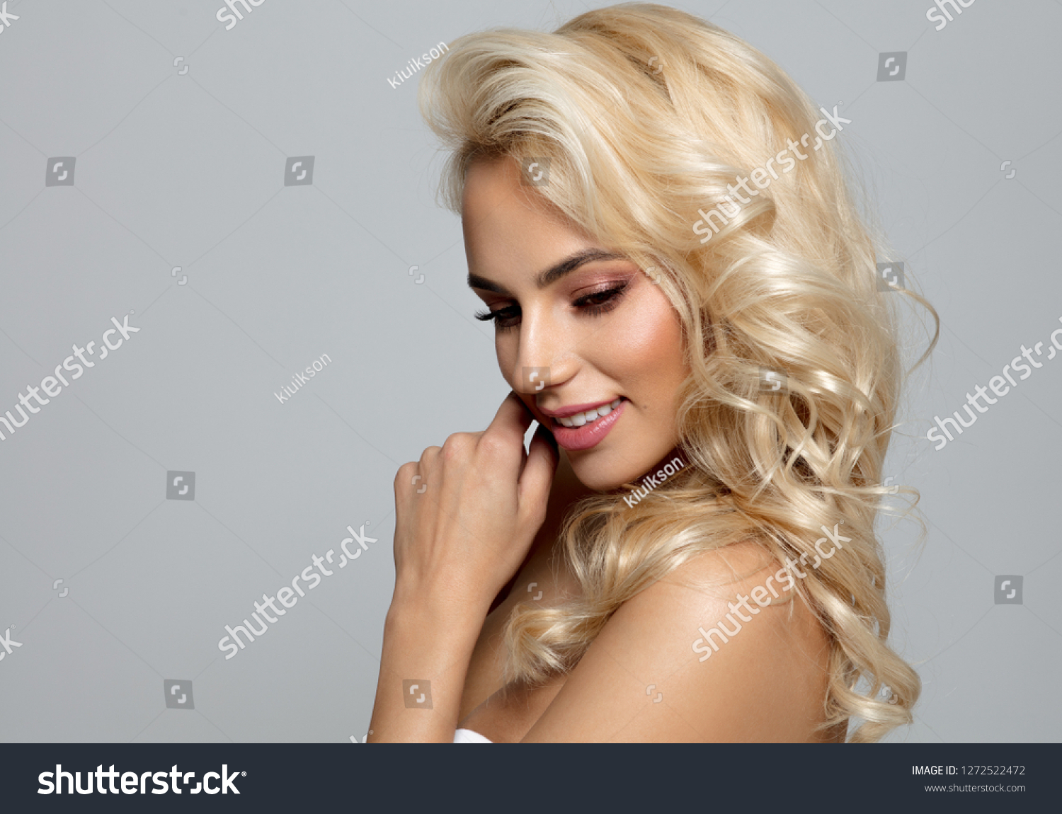 Photo of blond female model looking down #1272522472