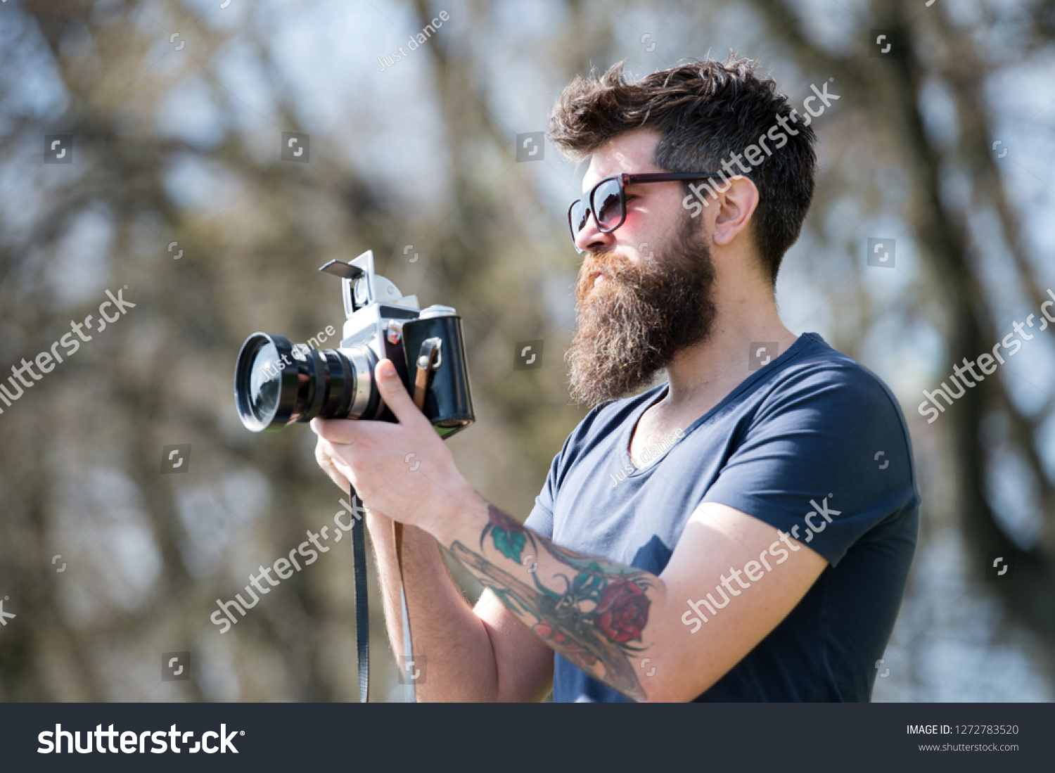 Man bearded hipster photographer hold vintage camera. Photographer with beard and mustache amateur photographer nature background. Man with long beard busy with shooting photos. Photographer concept. #1272783520