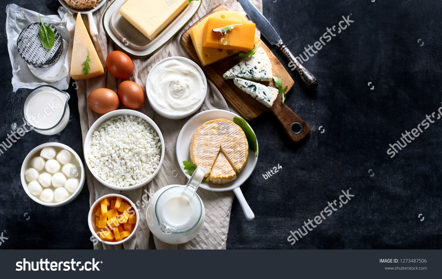 Dairy products.  Milk, cheese, sour cream, cottage, yogurt and butter on dark background. Flat lay with copy space #1273487506
