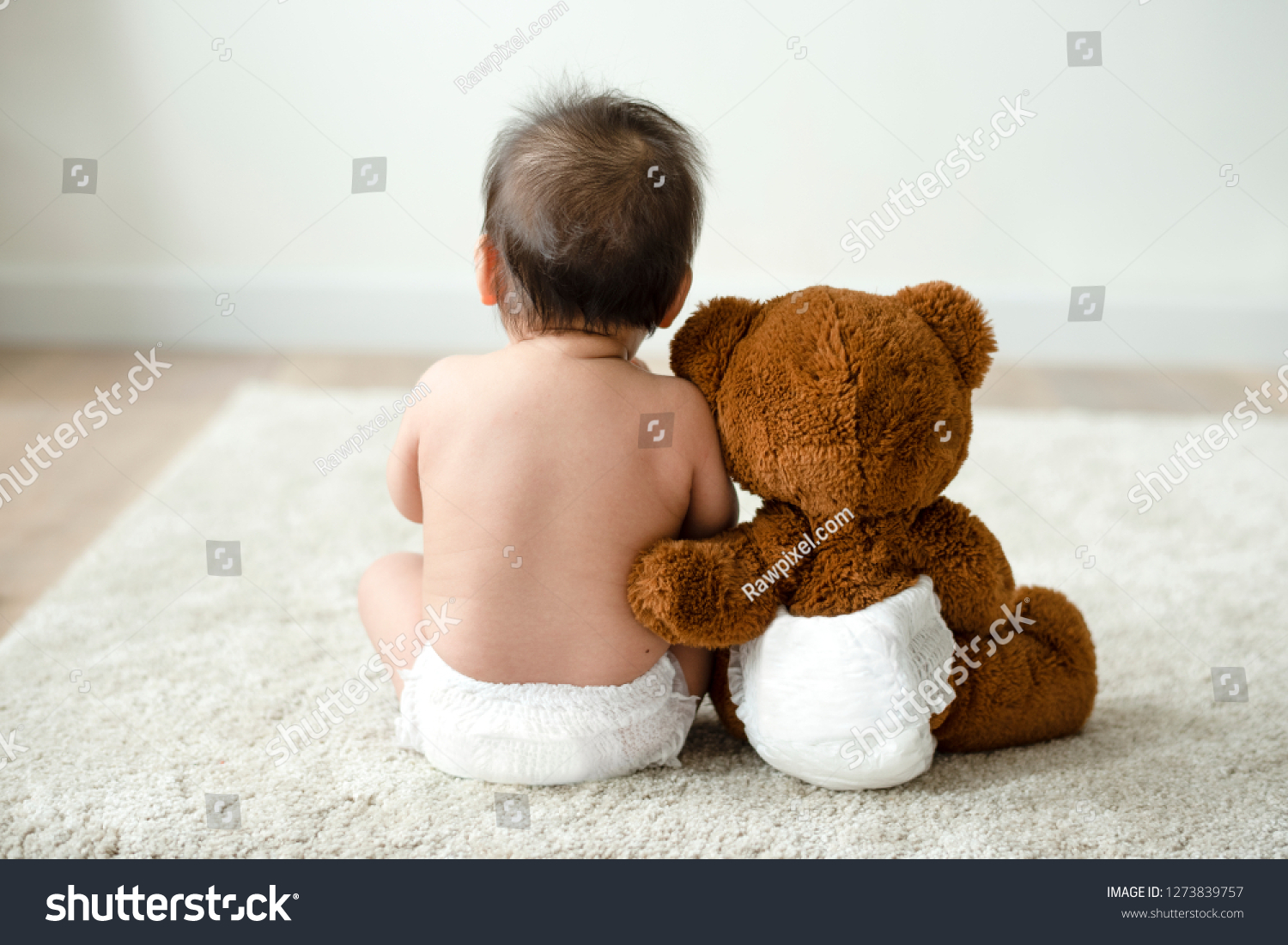 Back of a baby with a teddy bear #1273839757