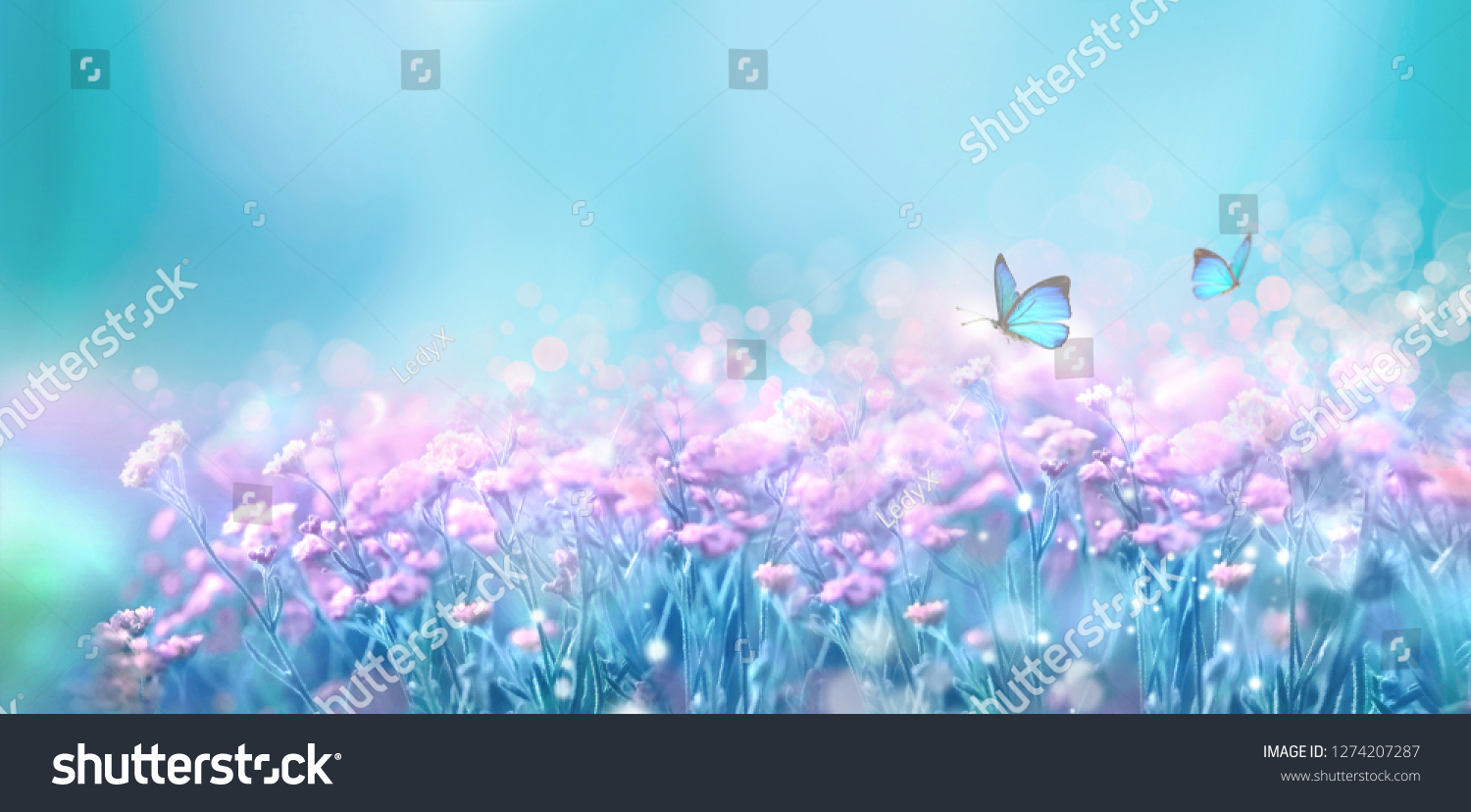 Floral spring natural landscape with wild pink lilac flowers on meadow and fluttering butterflies on blue sky background. Dreamy gentle air artistic image. Soft focus, author processing. #1274207287