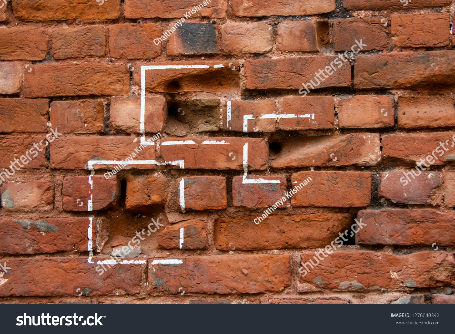 Bullet marks on a brick wall showing the atrocities of British rule in Indian subcontinent during east india rule #1276040392