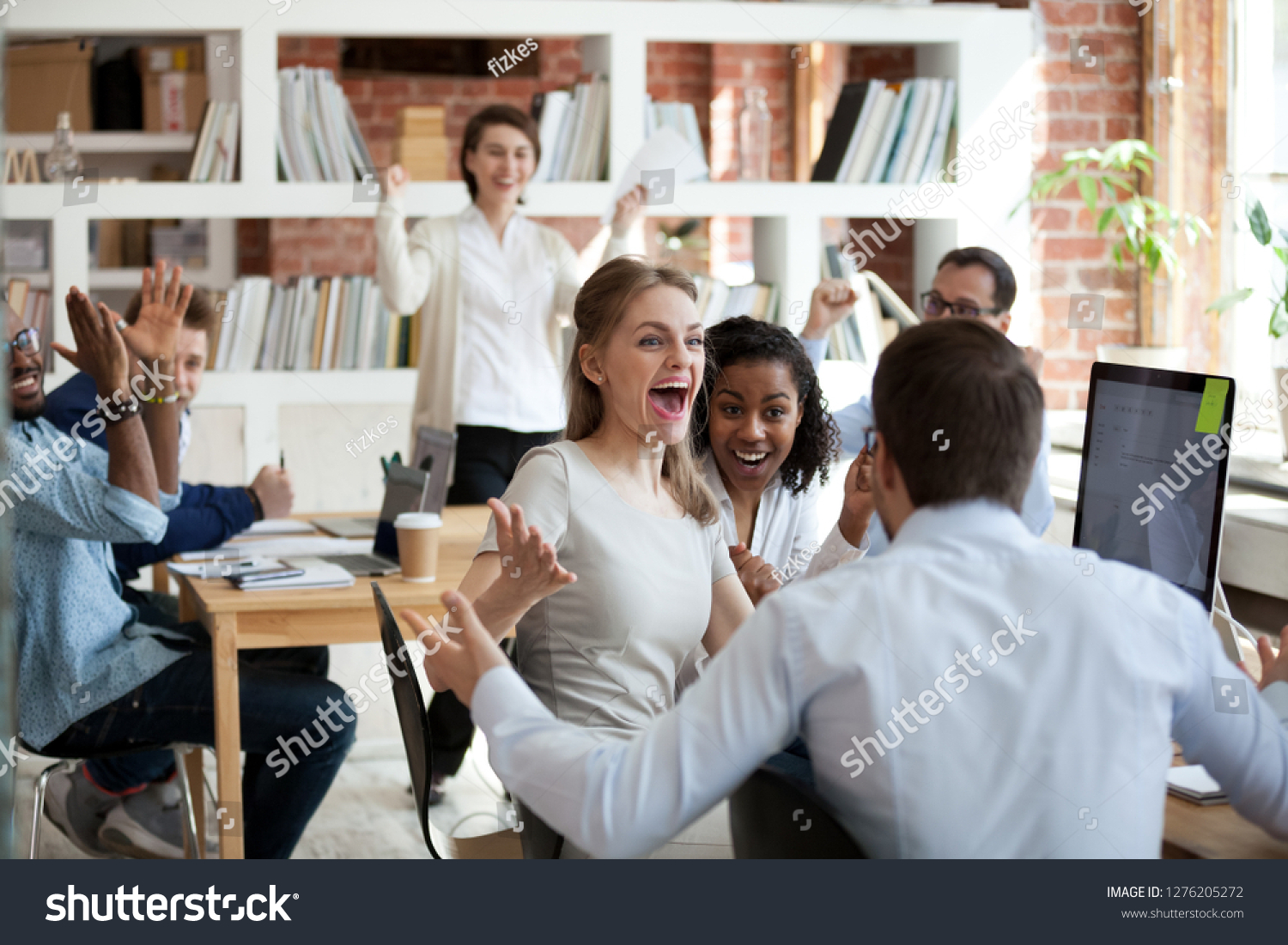 Excited diverse business team employees screaming celebrating good news business win corporate success, happy multi-ethnic colleagues workers group feeling motivated ecstatic about great achievement #1276205272