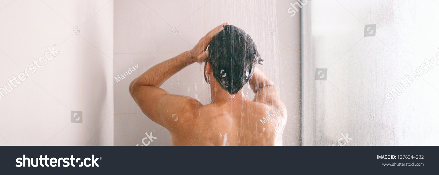 Shower man washing hair rinsing shampoo in bathroom banner panorama. Showering person at home lifestyle. Young guy taking a shower. #1276344232