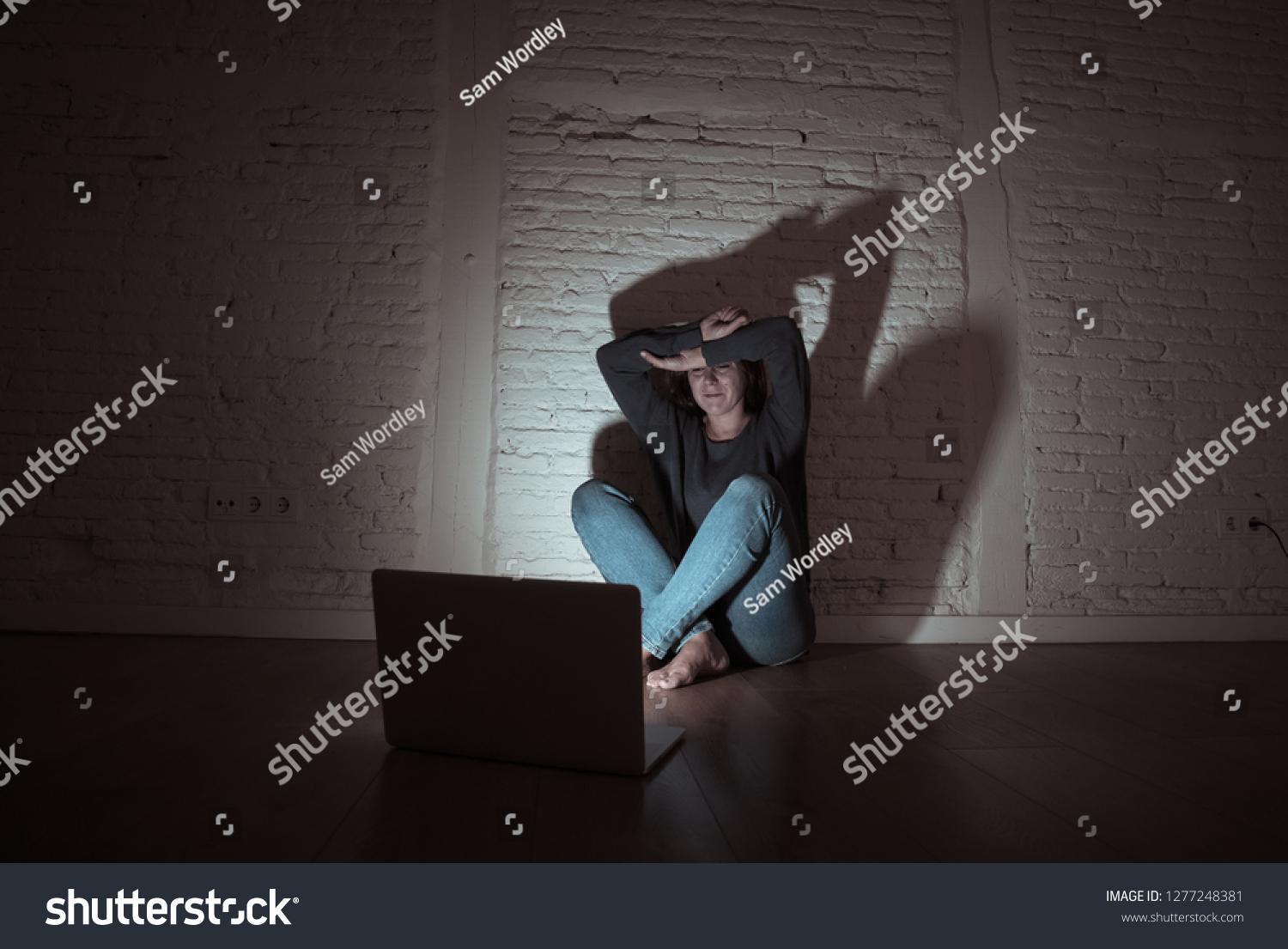 Sad and scared female Young woman with computer laptop suffering cyberbullying and harassment being online abused by stalker or gossip feeling desperate and humiliated in cyber bullying concept. #1277248381
