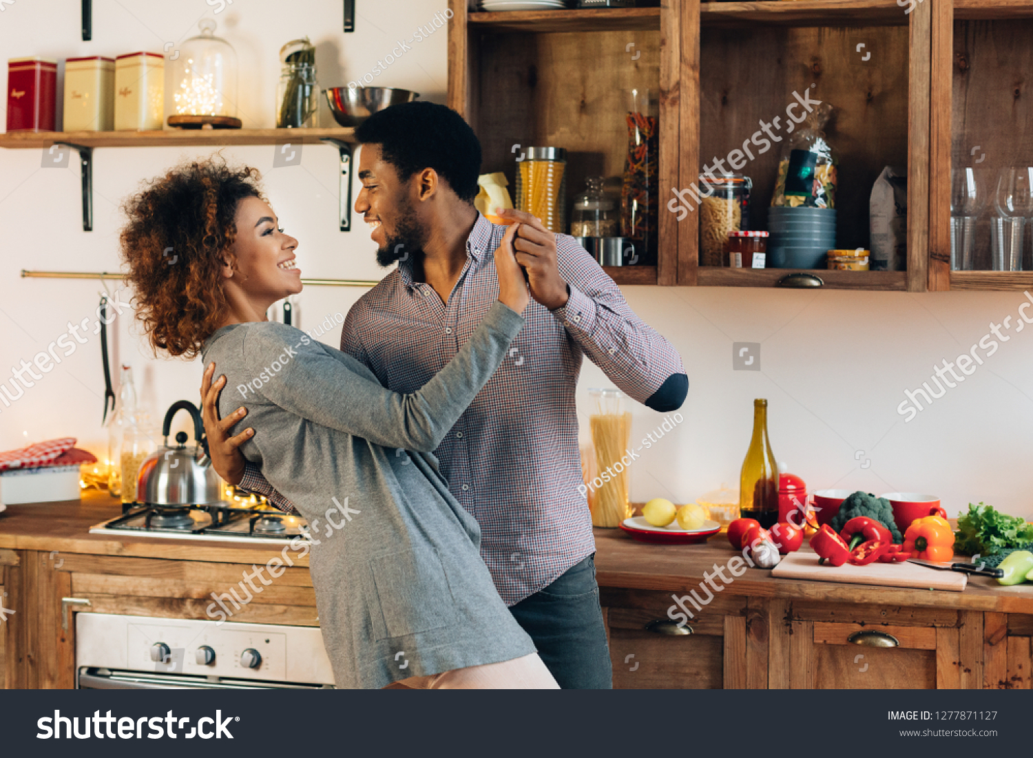 Happy moments. Young african-american couple in love dancing in kitchen, copy space #1277871127