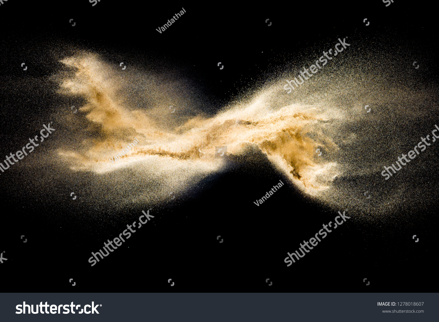 Golden sand explosion isolated on black background. Abstract sand cloud. Golden colored sand splash against dark background. Yellow sand fly wave in the air. #1278018607