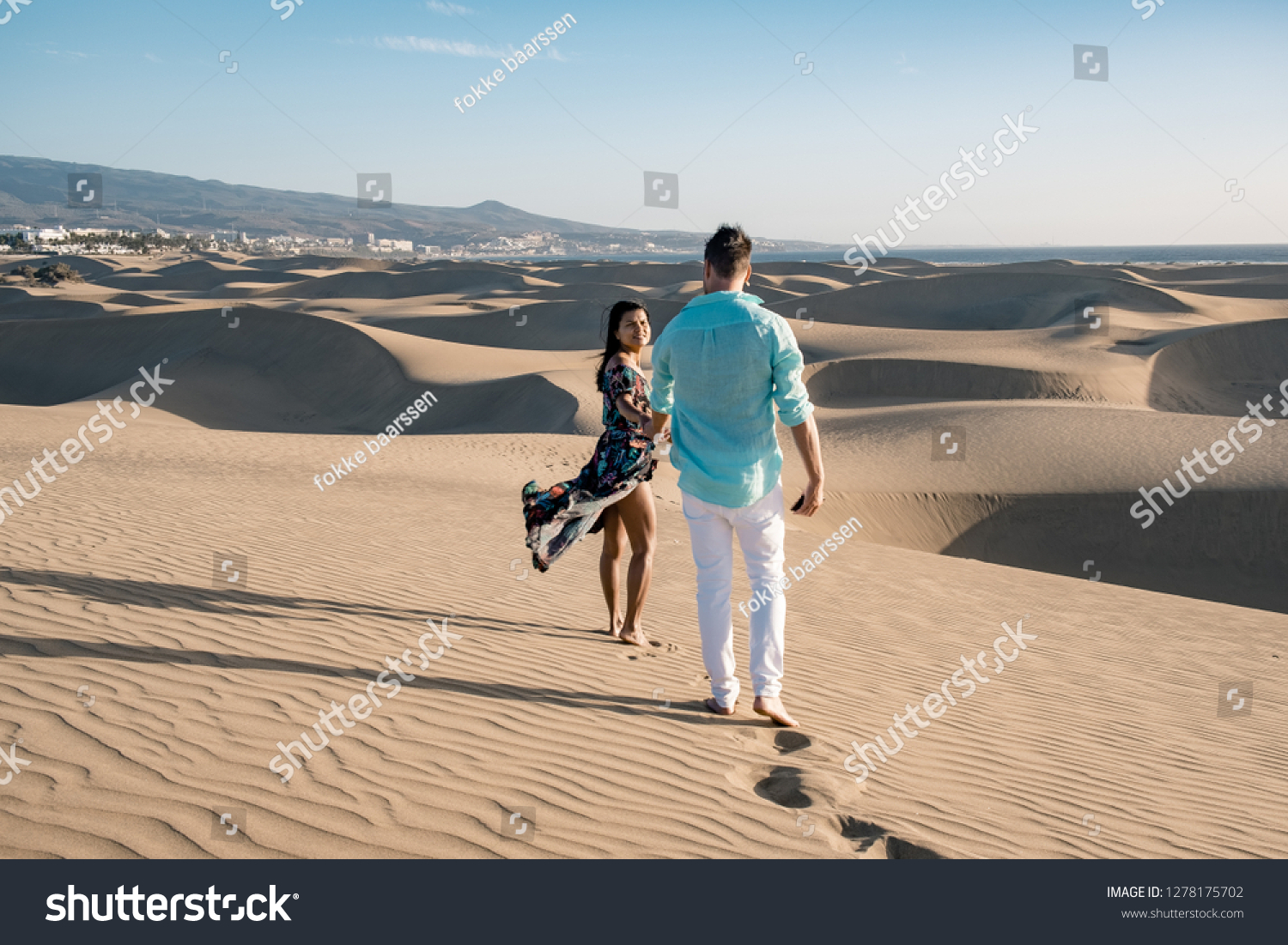 couple walking at the beach of Maspalomas Gran Canaria Spain, men and woman at the sand dunes desert of Maspalomas #1278175702