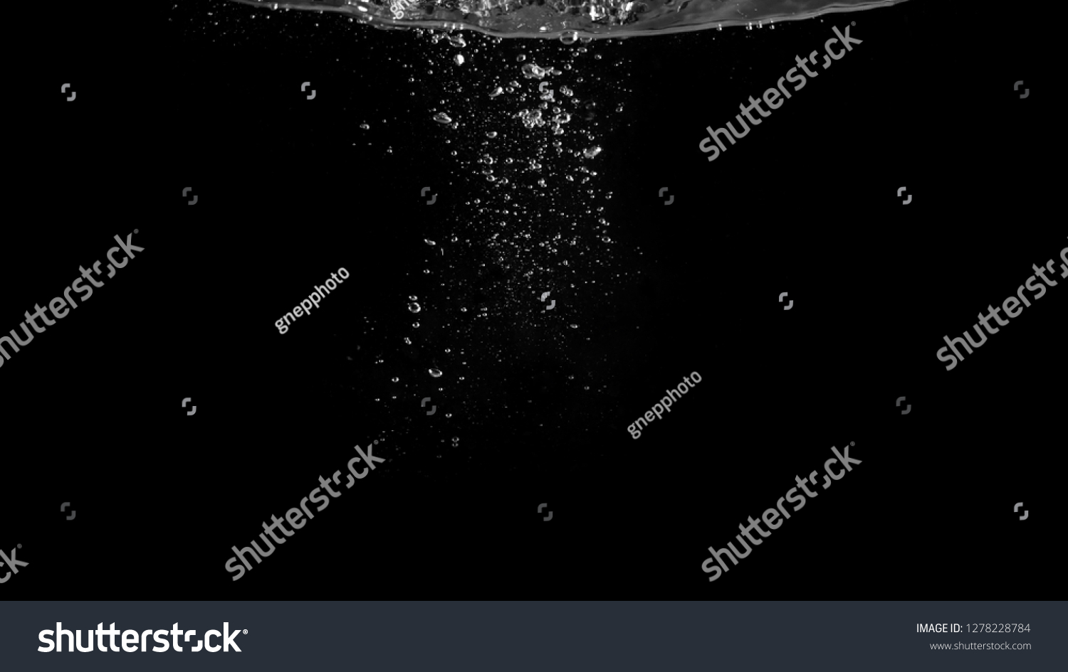 Close-up images of soda water bubbles floating up to top of water surface which little and big circle texture splashing up by gas power in carbonate drink make refreshing moment on black background #1278228784
