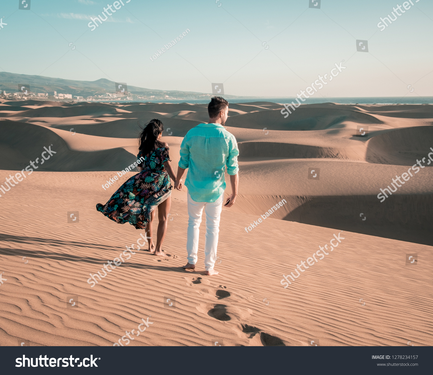couple walking at the beach of Maspalomas Gran Canaria Spain, men and woman at the sand dunes desert of Maspalomas #1278234157