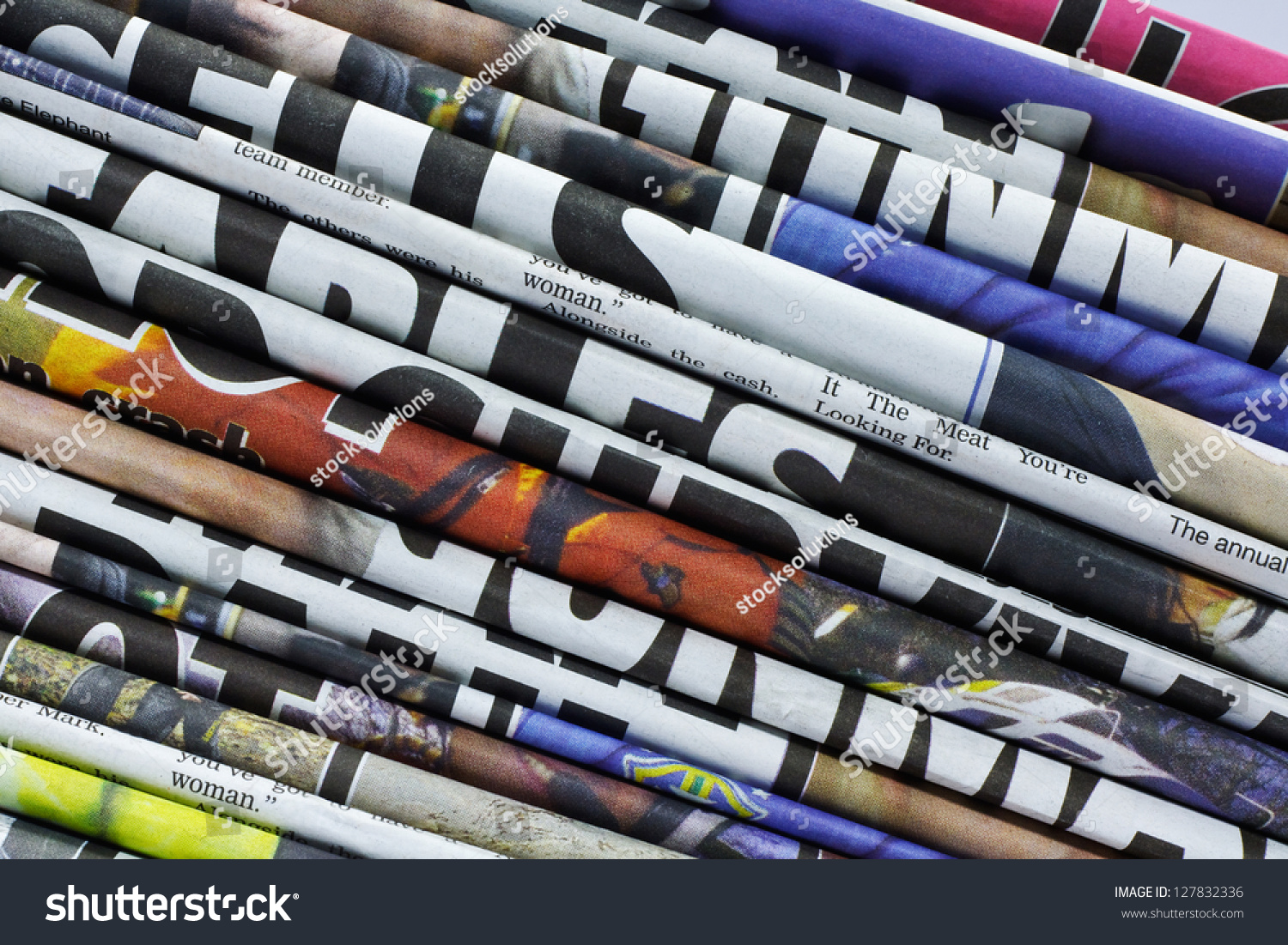 close up on a pile of differnt color newspaper titles #127832336
