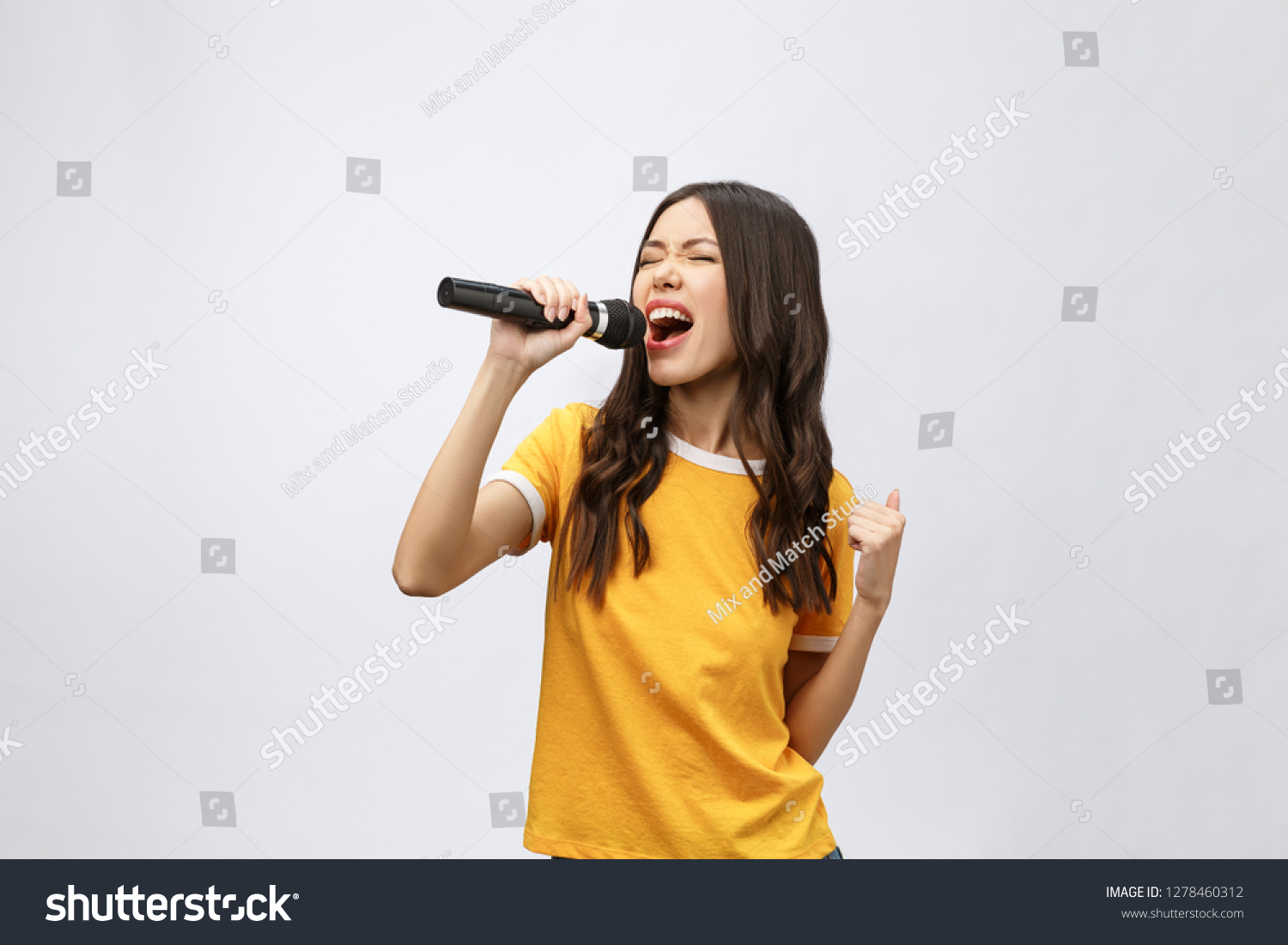 beautiful stylish woman singing karaoke isolated over white background. #1278460312