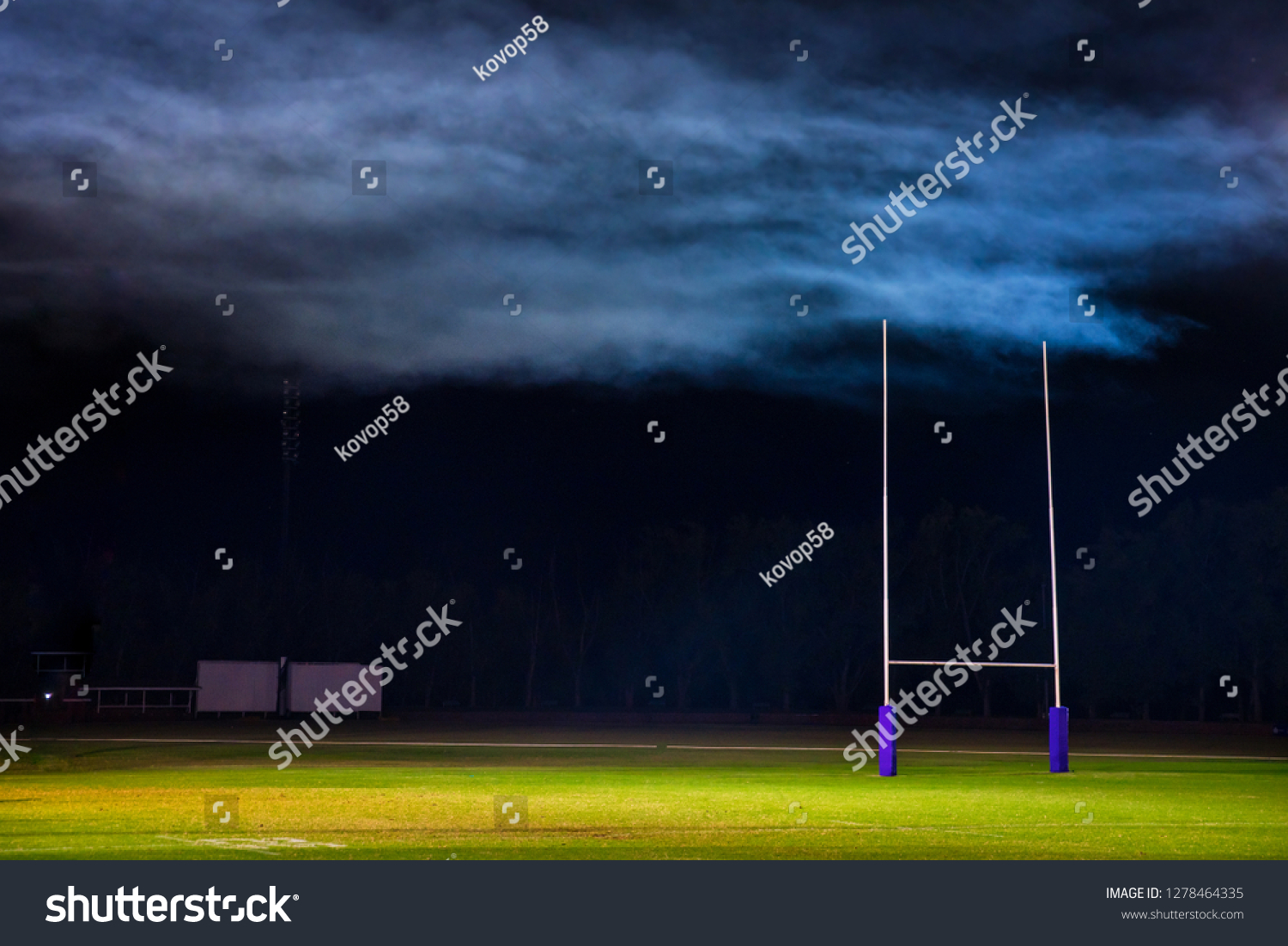 Goal posts for football, rugby union or league on field at night. Dark edit space #1278464335