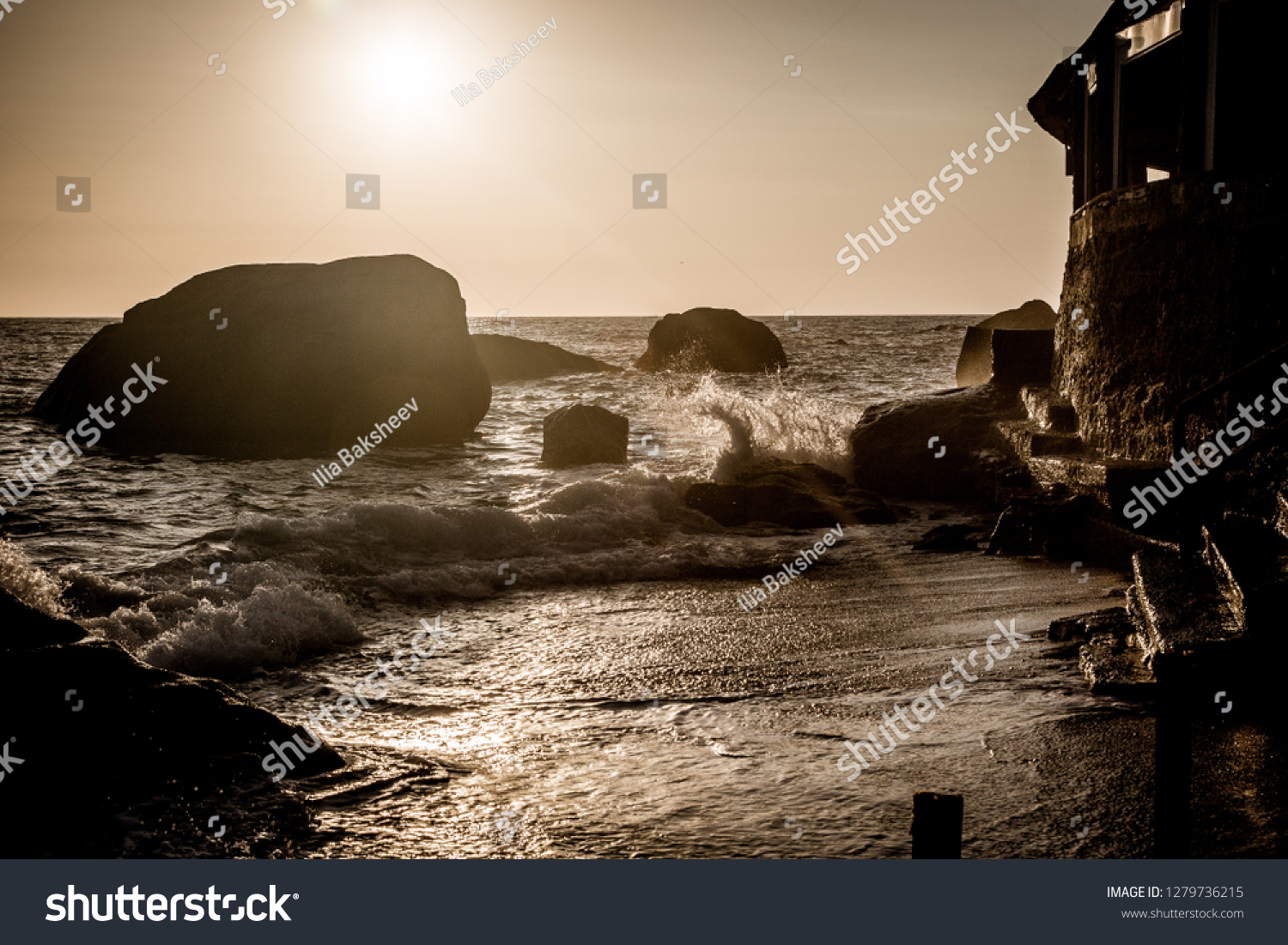 Stormy sea at sunset, the spray of the surf in the setting sun. Ischia Island, Italy.
 #1279736215