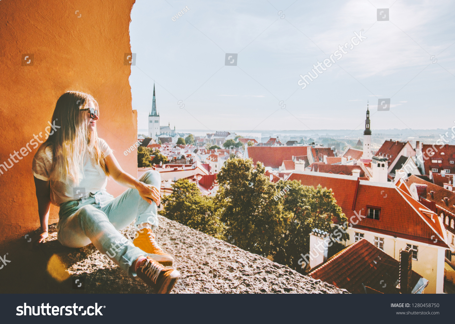 Woman sightseeing Tallinn city landmarks  vacations in Estonia travel lifestyle girl tourist relaxing at viewpoint Old Town aerial view architecture  #1280458750