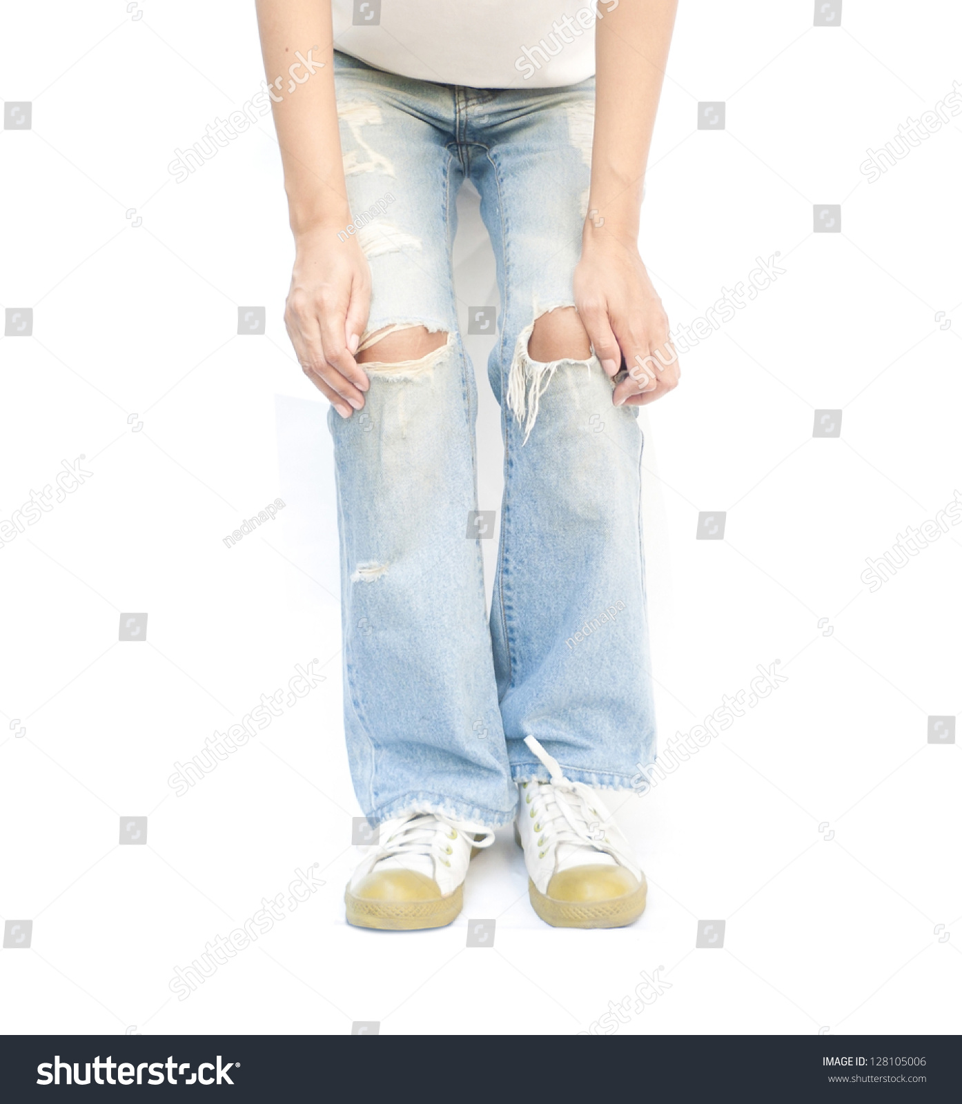 Young woman wearing torn jeans. #128105006