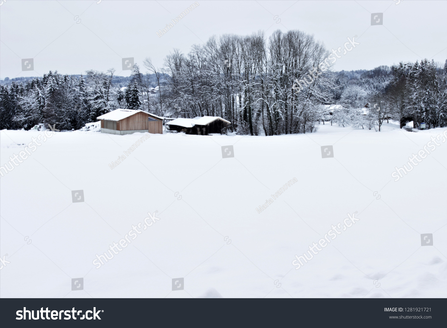 Huts in a wintry landscape #1281921721
