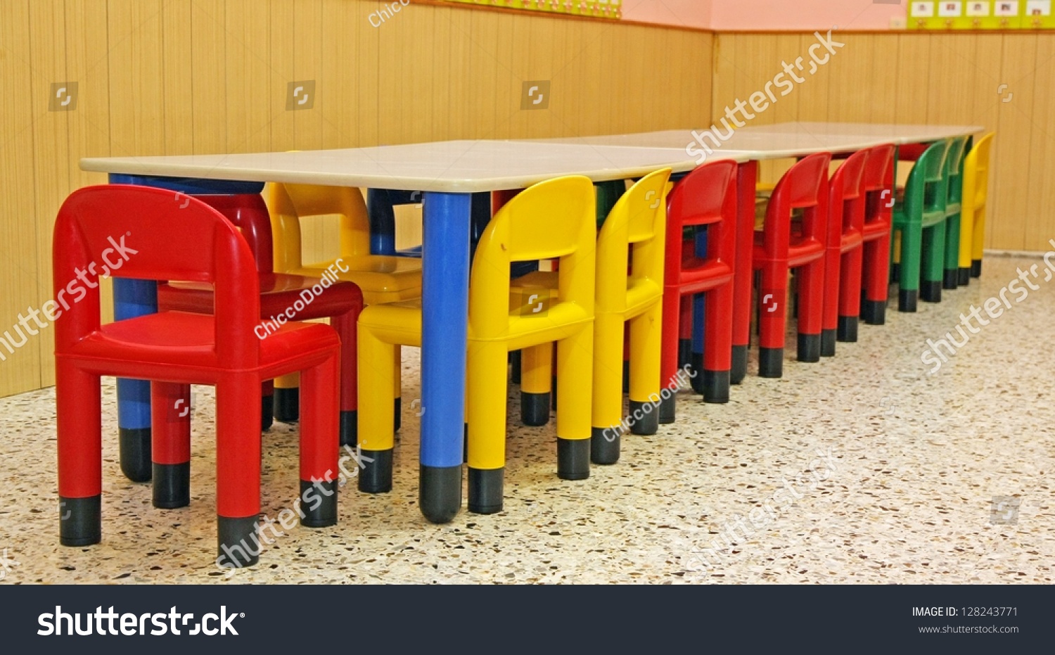 colored plastic chairs and a table in the refectory of the preschool children #128243771