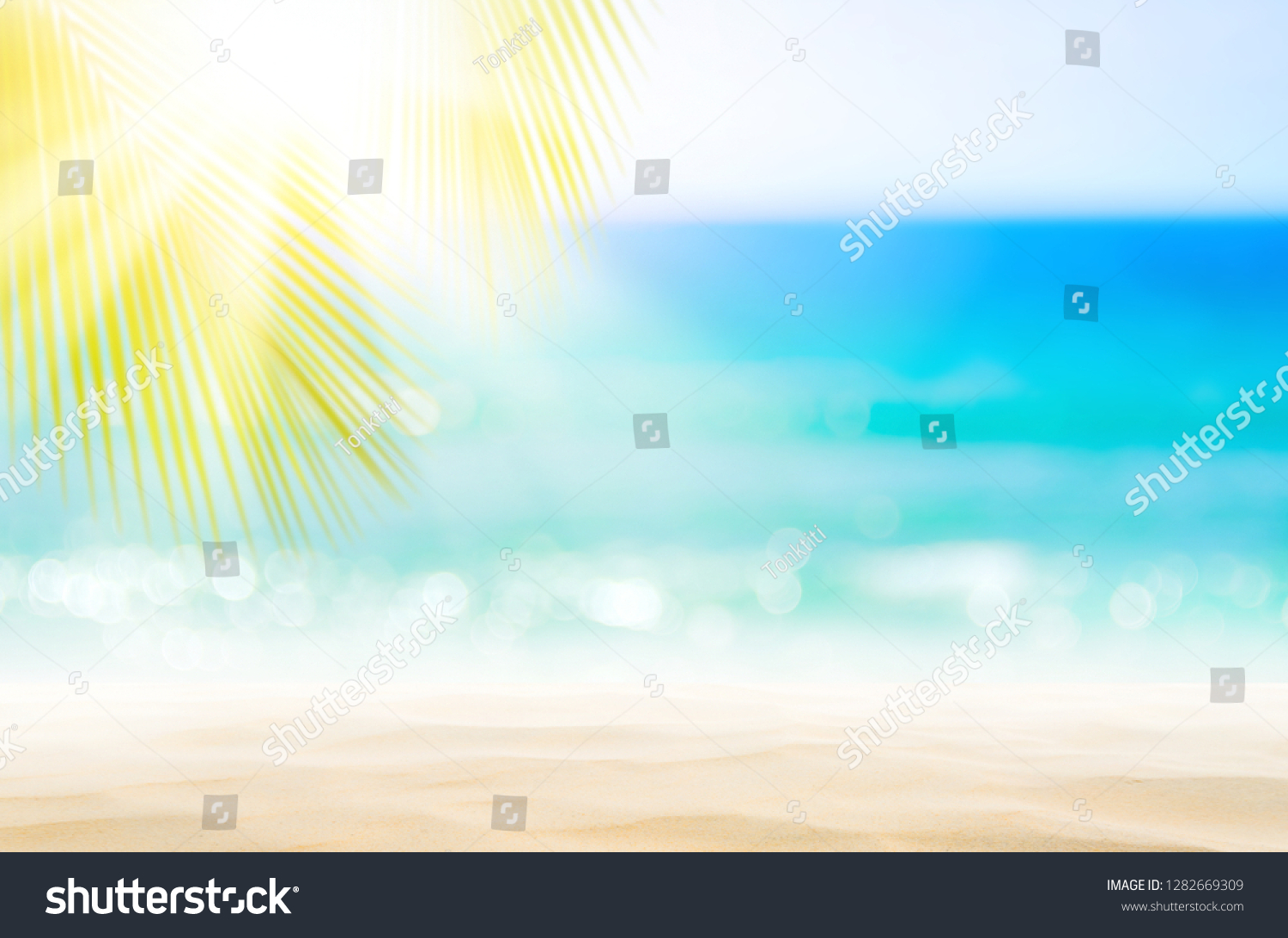 Blur beautiful nature green palm leaf on tropical beach with bokeh sun light wave abstract background. Copy space of summer vacation and business travel concept. Vintage tone filter effect color style #1282669309